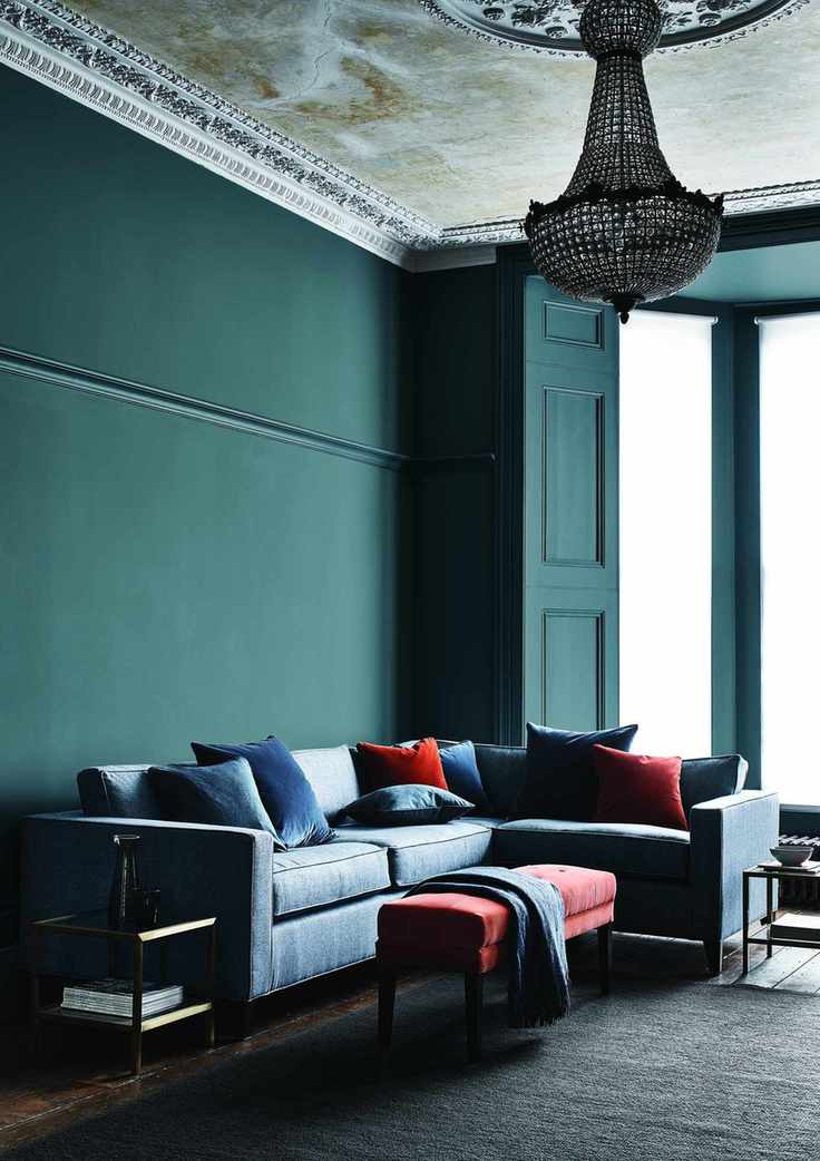 Living room with sectional and dark walls and chandelier