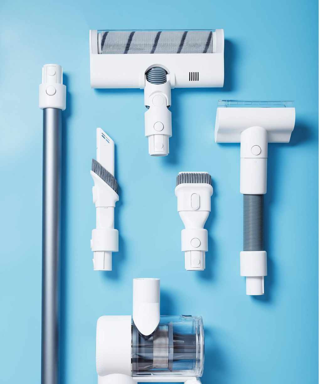 Vacuum cleaner attachments on blue background