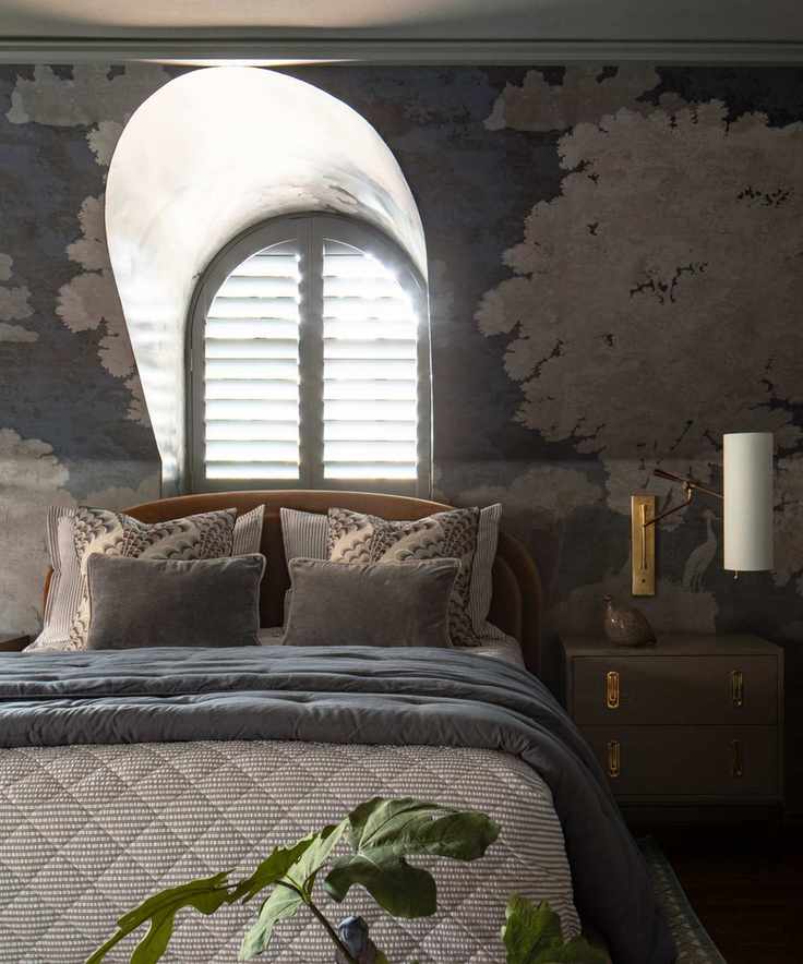 moody bedroom with mural wallpaper and a soft blue color scheme