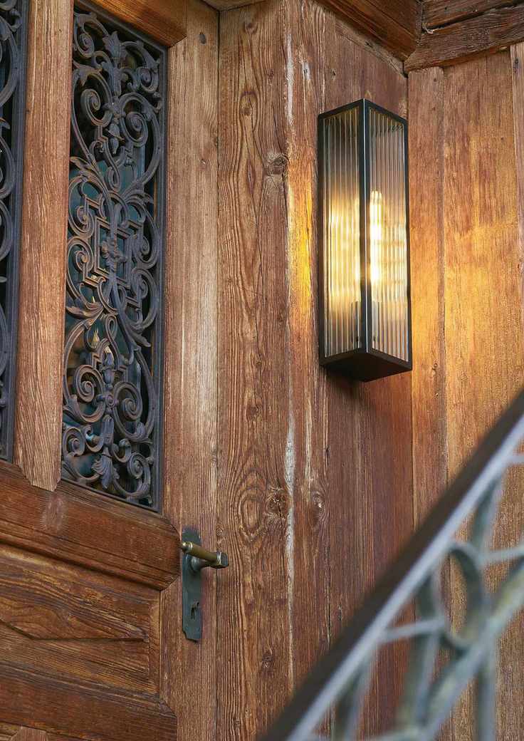 contemporary wall lantern with ribbed glass on wooden exterior wall