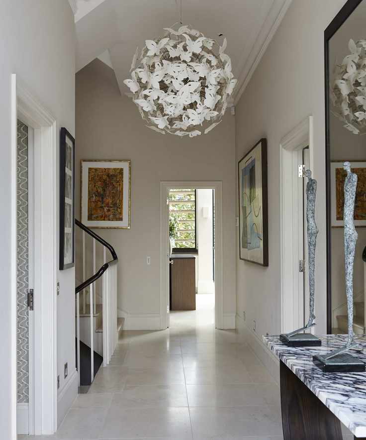 A modern hallway featuring a unique chandelier