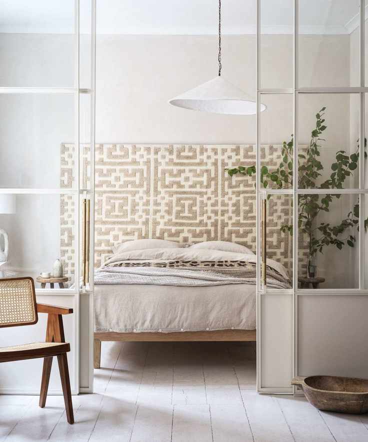 japandi style bedroom with rattan detail and a large plant