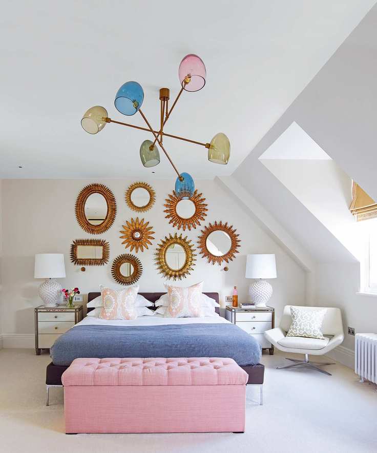 A stylish bedroom featuring a sputnik chandelier with colorful bulbs