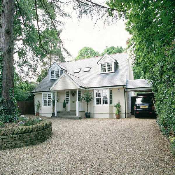 Gravel driveway leading to a converted bungalow