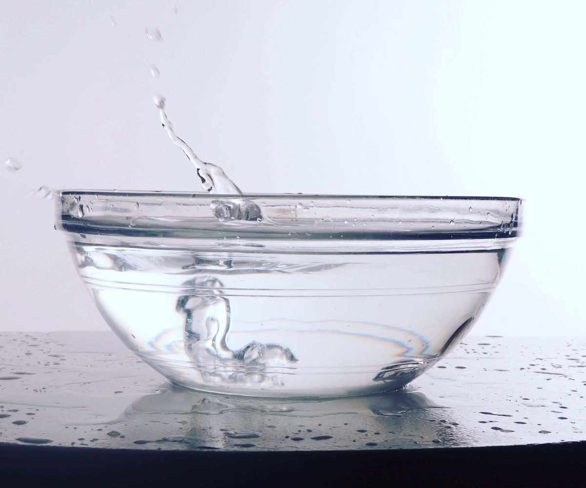 A small glass bowl of white vinegar