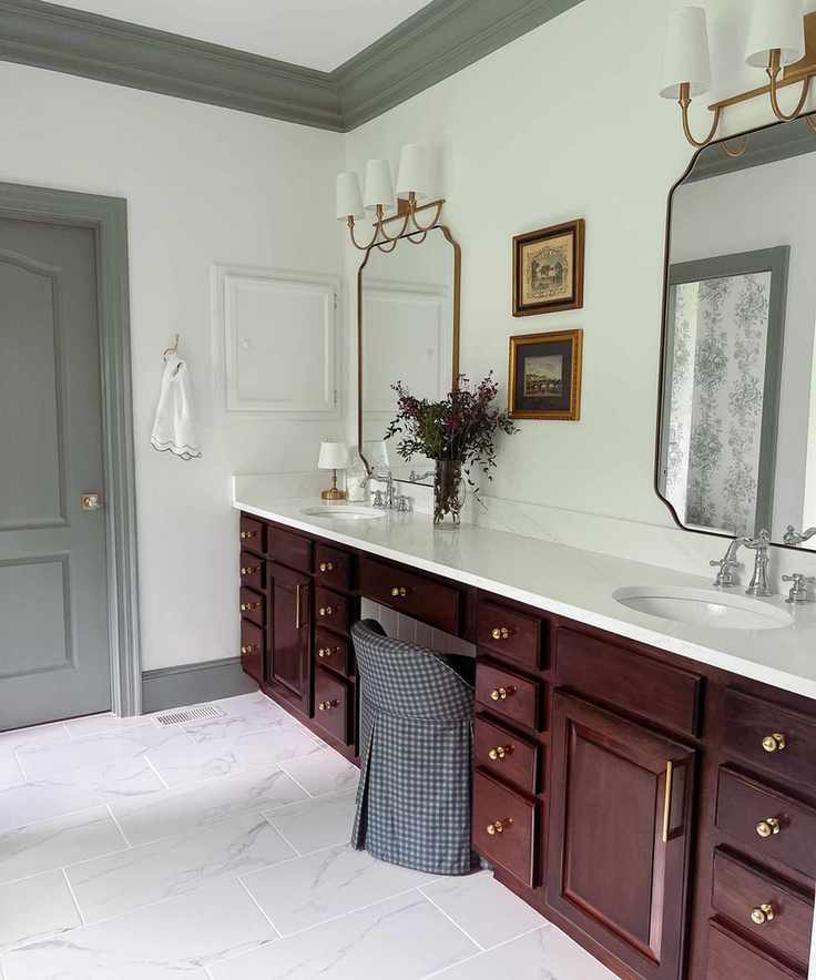 Bathroom featuring mahogany cabinets, cream walls, and vintage decor