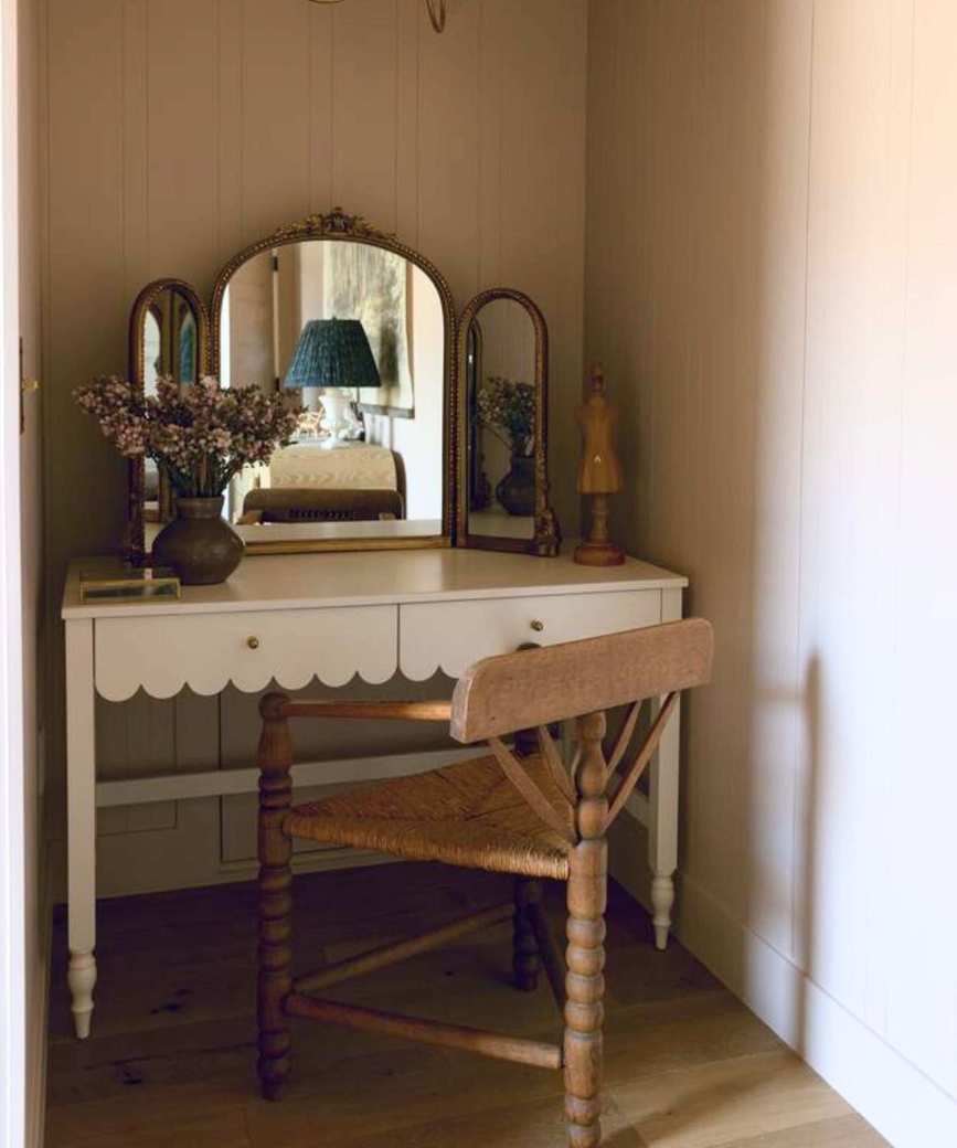 dressing table with scalloped edge and three-legged chair with bobbin detail on legs. A standalone antique mirror