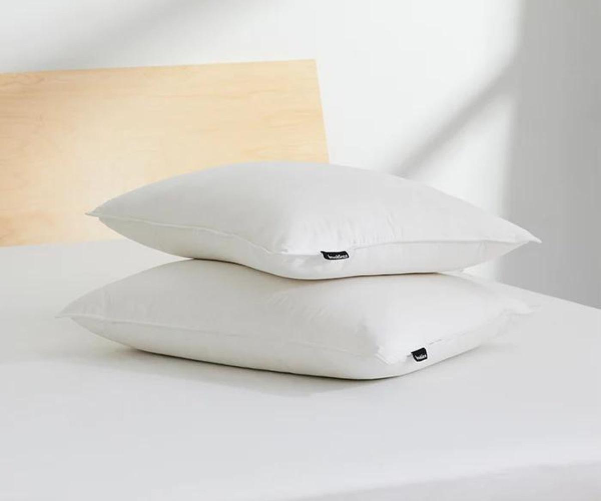 Two Brooklinen Down Pillows on a mattress.