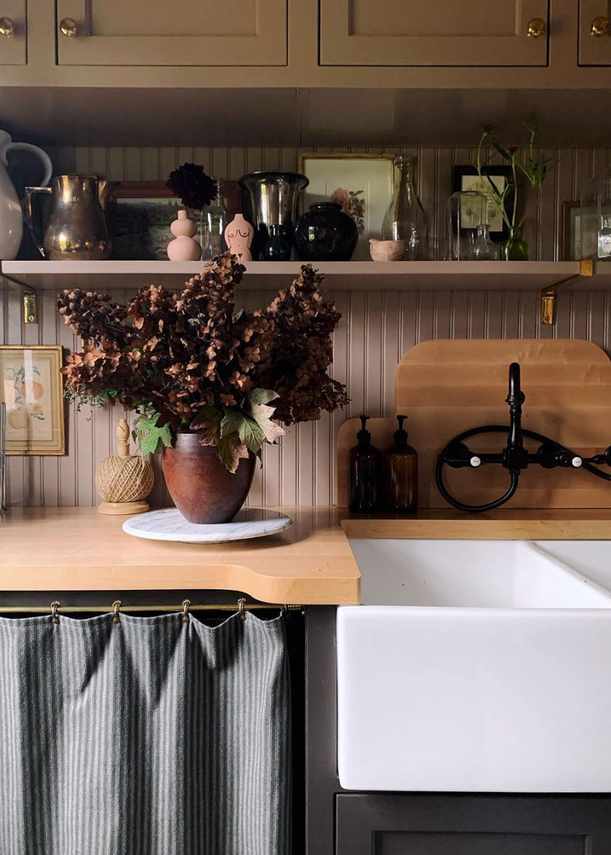Laundry room in a cozy wooden design with decorative elements.