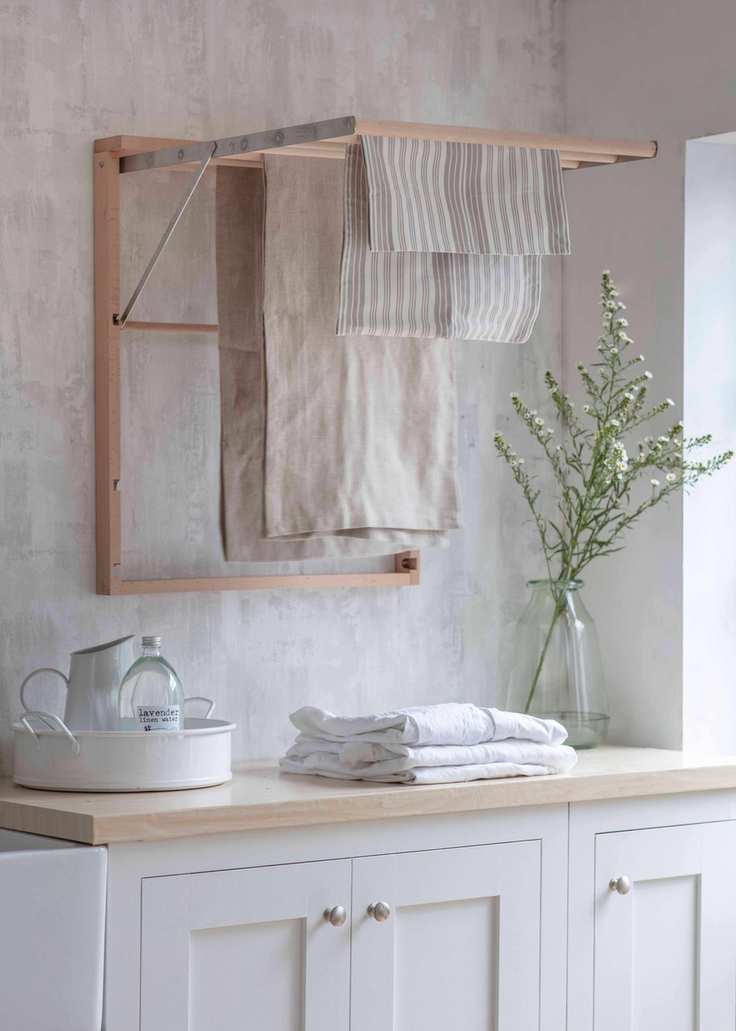 Laundry room with a fold-out drying rack in a neutral color scheme.