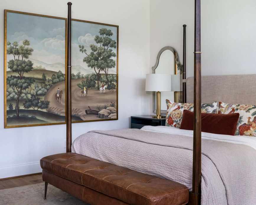 neutral bedroom with wooden four poster bed, beige bedding and vintage accents