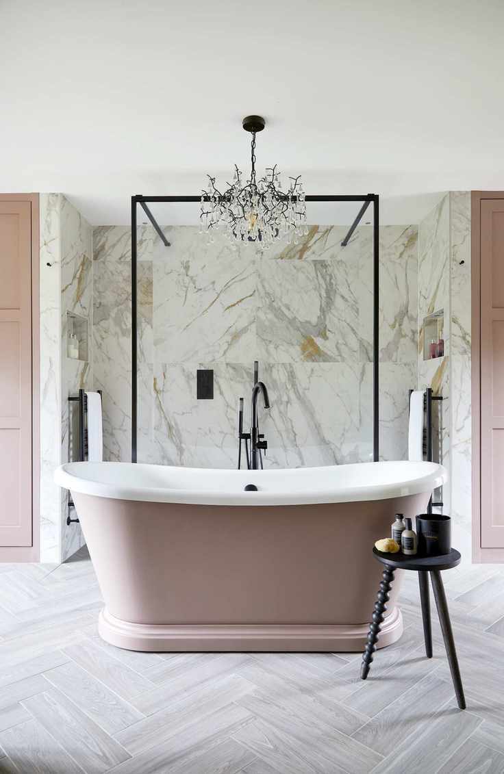 pink bath with chandelier above