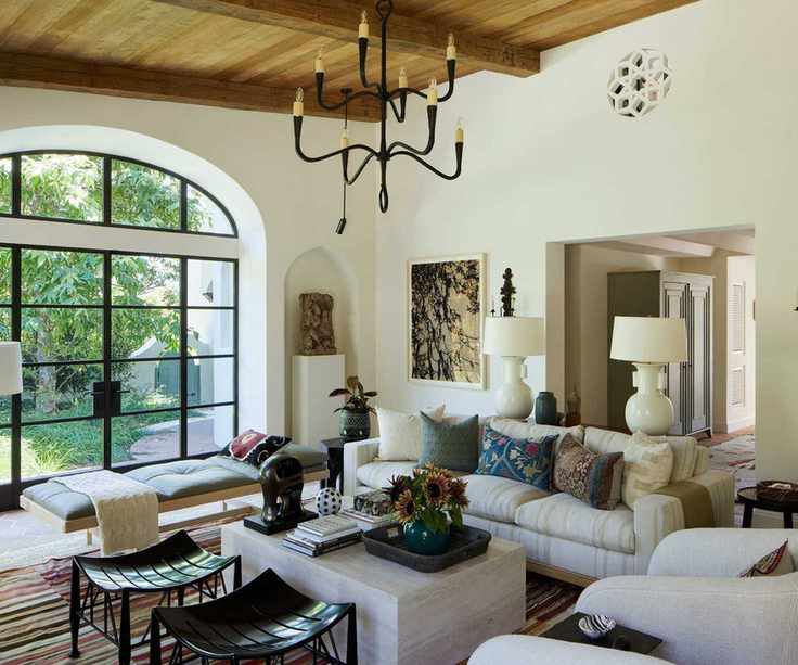 Bright living room with arched glass doors and a mix of seating styles