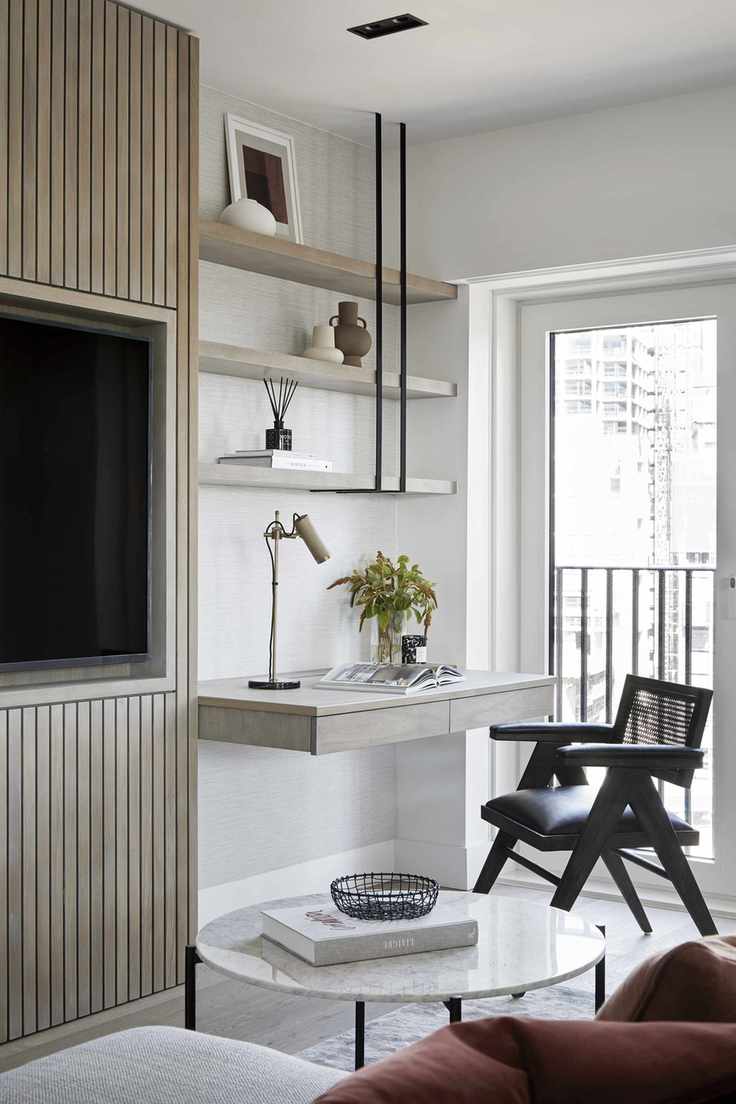 Living room with media wall and built-in desk in neutral colors