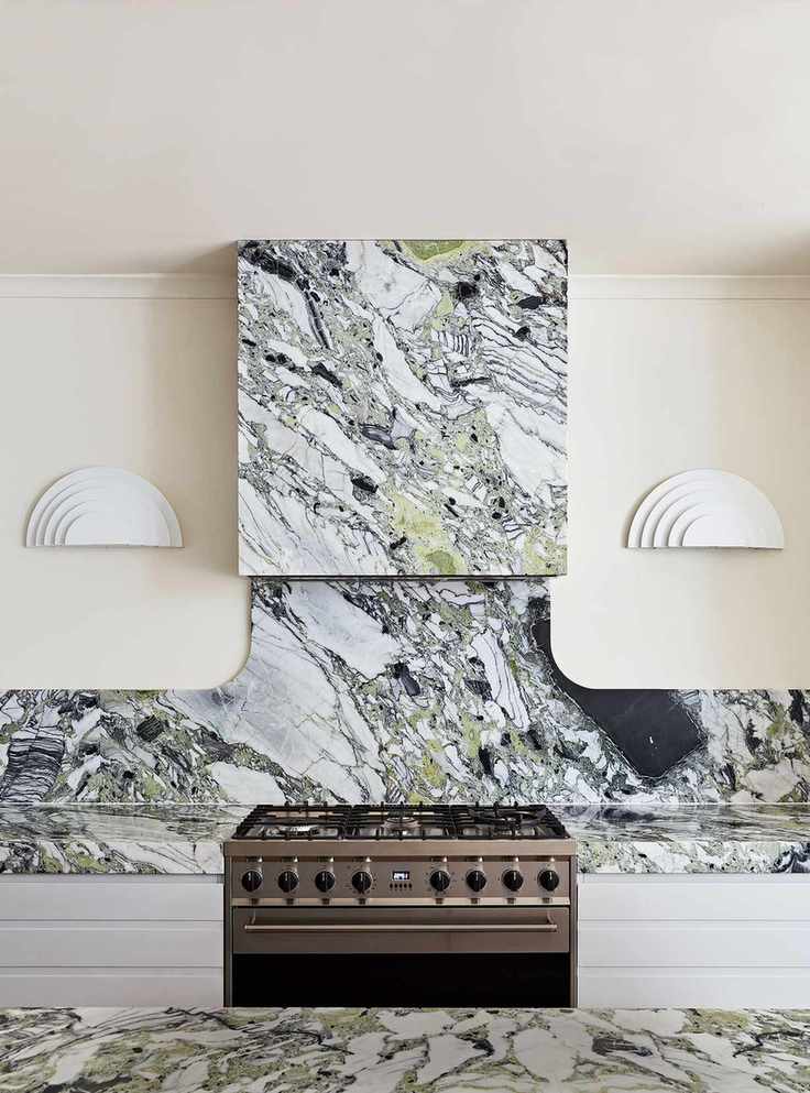 Cream kitchen with black and white marble backsplash