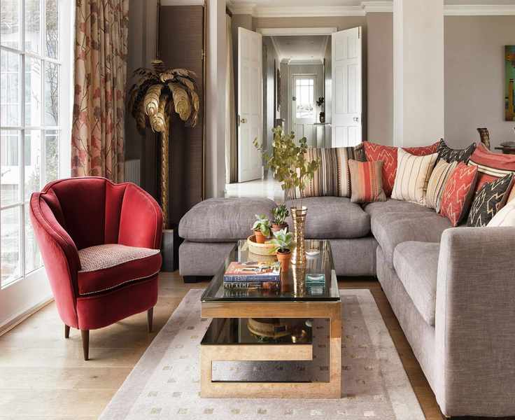 Living room rug ideas with neutral rug, wood floor and red chair