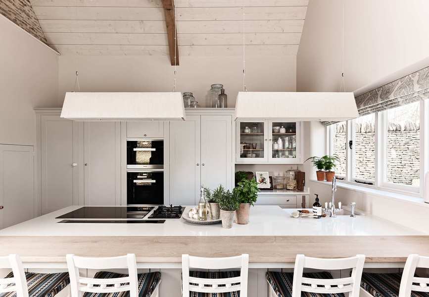 miniamlist white country kitchen with versatile peninsula