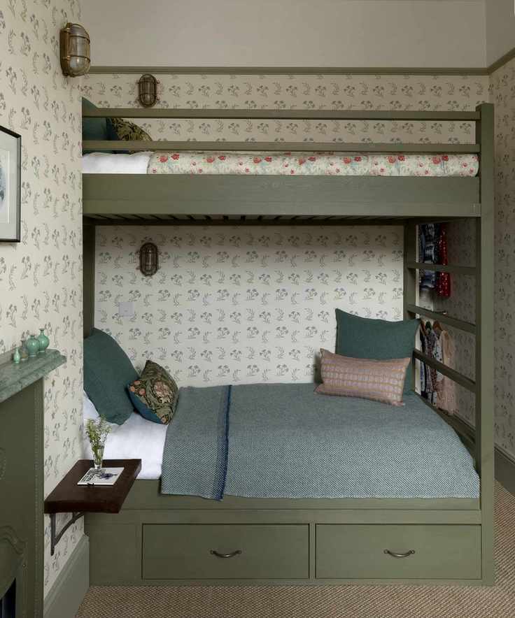 A green loft bed with two bunks in a charming bedroom