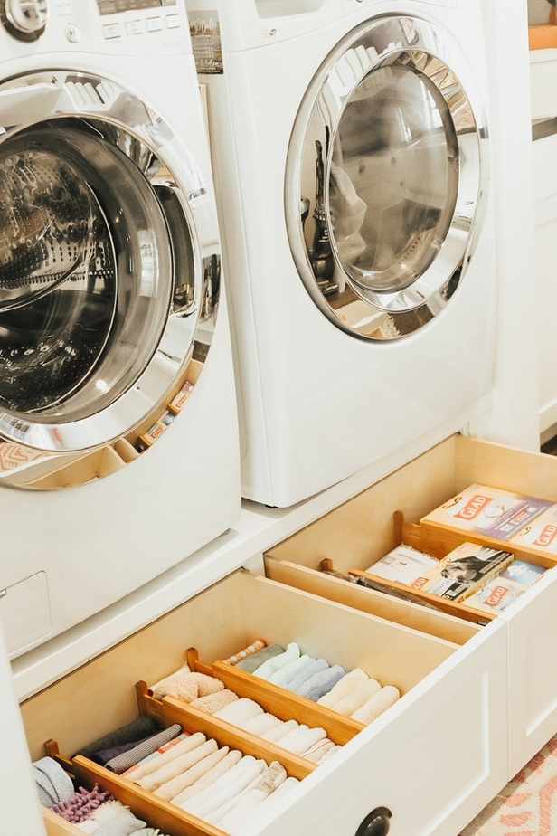 Laundry pedestal with storage drawers.
