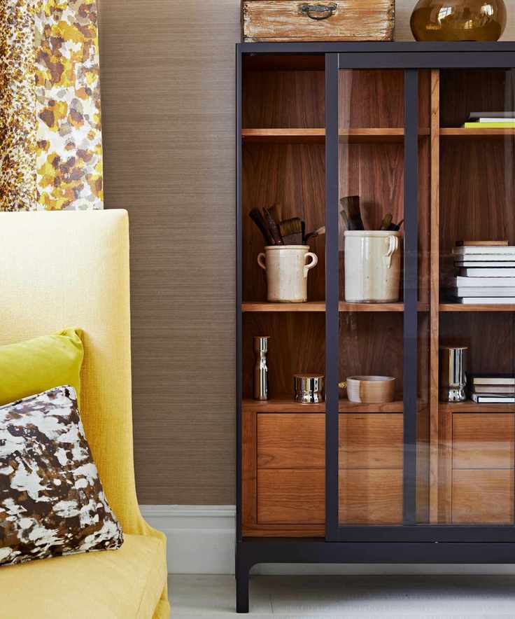 Wooden glass-fronted dresser with yellow accents