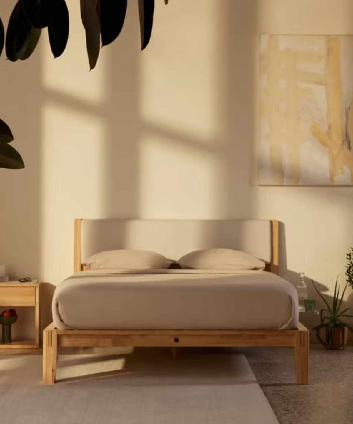 Mattress and pillows on a Thuma bed frame against cream walls.