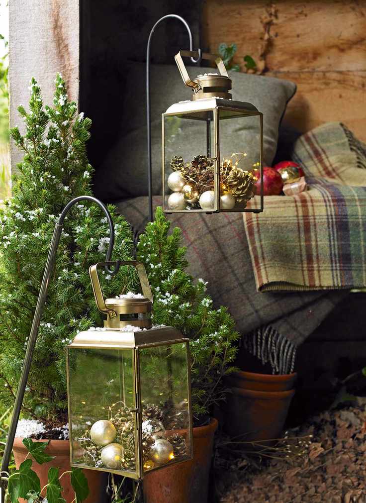 Pine cones and baubles in outdoor lanterns