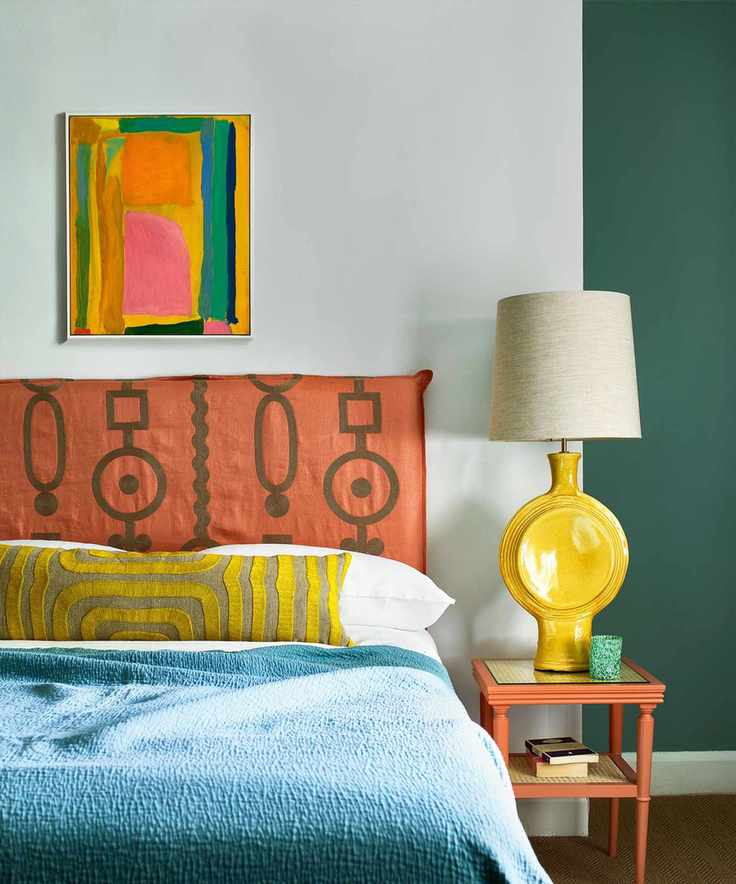 Colorful bedroom with bright walls and abstract art over bed