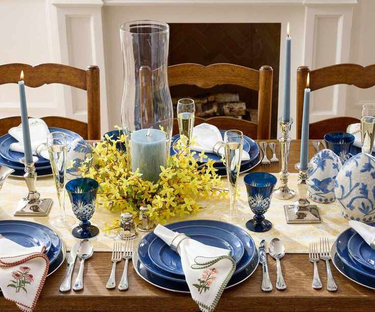 Blue tableware with floral embroidered napkins, yellow floral mini wreath and candles