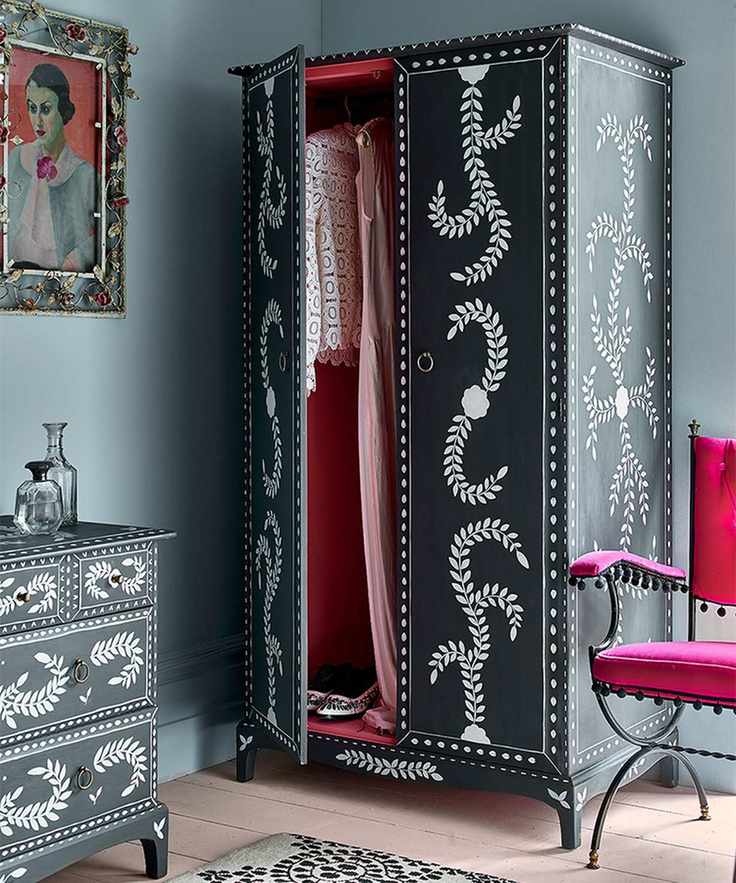 Bedroom paint idea with blue wall and black painted wardrobe with pearl detail