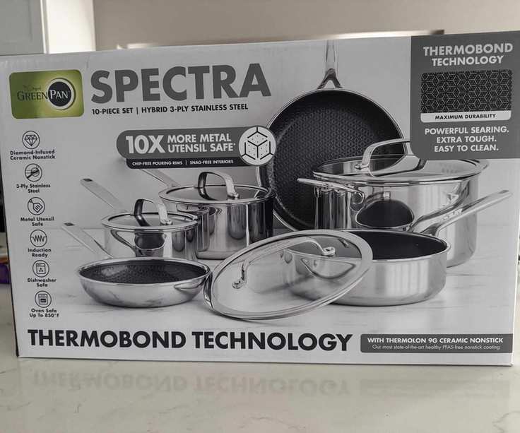 The full GreenPan Spectra Thermobond pan set in a white box on a kitchen counter.