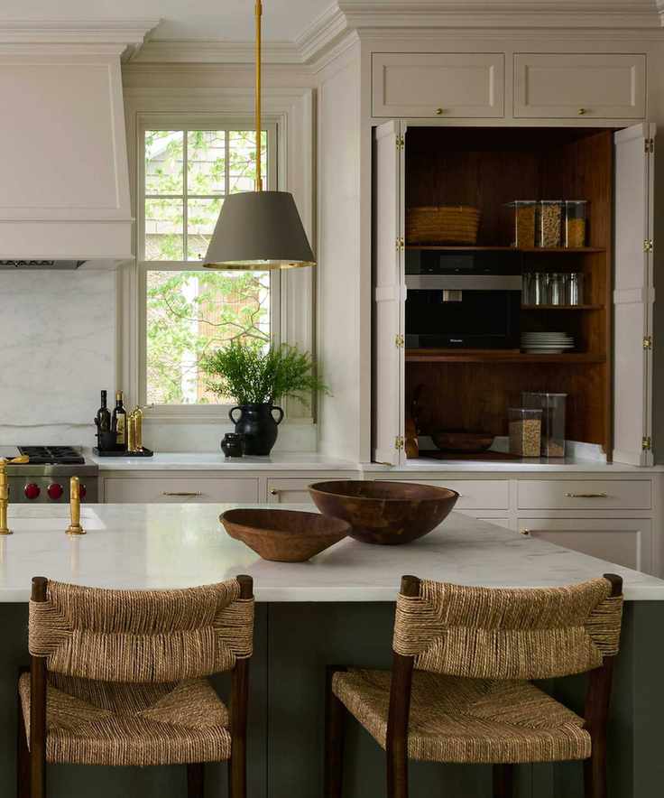 A warm white kitchen with a large cabinet that's been turned into a pantry