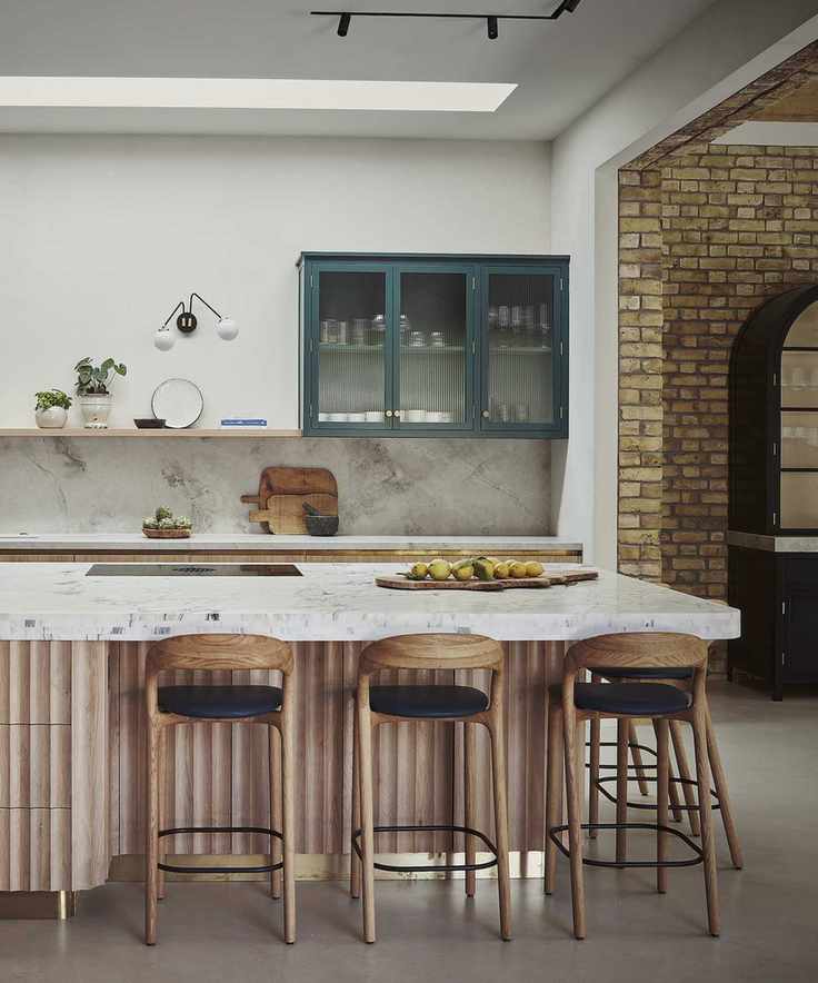 wood kitchen island with ribbed sides and bar stools