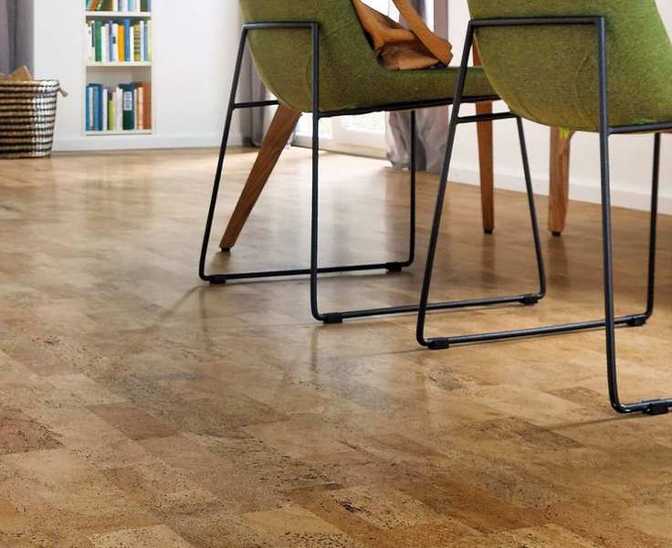 Cork flooring showcased in a stylish white room with green accents and black chairs.