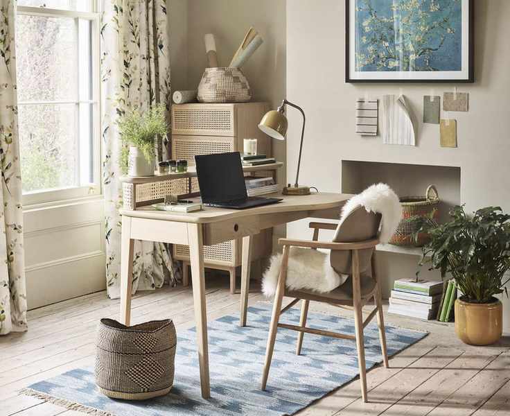 home office with botanical curtains and midcentury desk