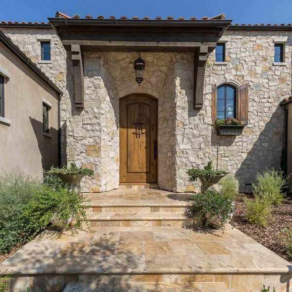 exterior of new built Spanish revival style villa with blue sky