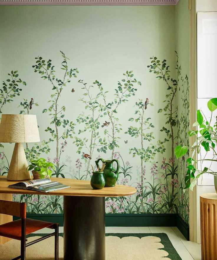 Green mural wallpaper with wood desk and paper lamp and orange leather chair