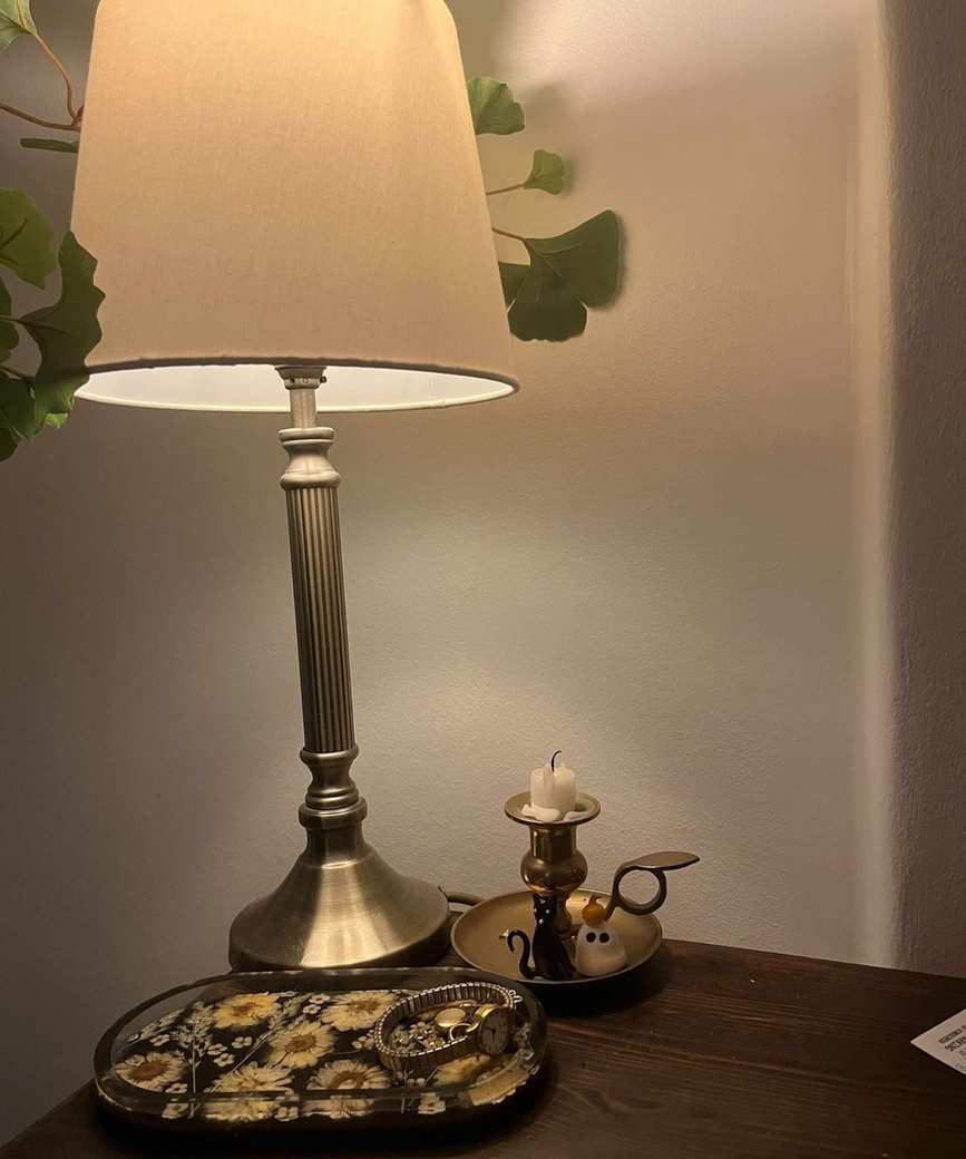 A bedside lamp featuring a Philips Hue bulb emitting warm light