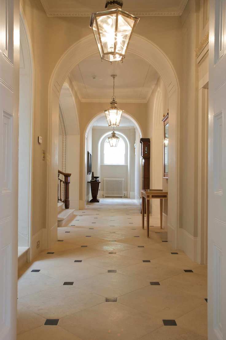 elegant arched hall in a period home with stone floor tiles