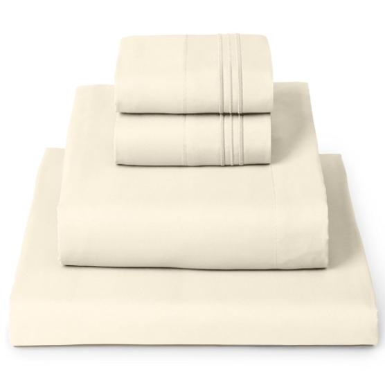 a stack of beige luxury bedding folded up into a neat pile