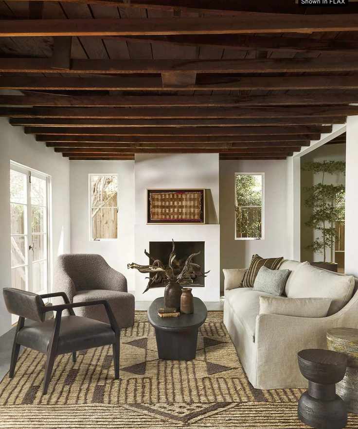 White living room with wooden beams and cream slipcovered sofa