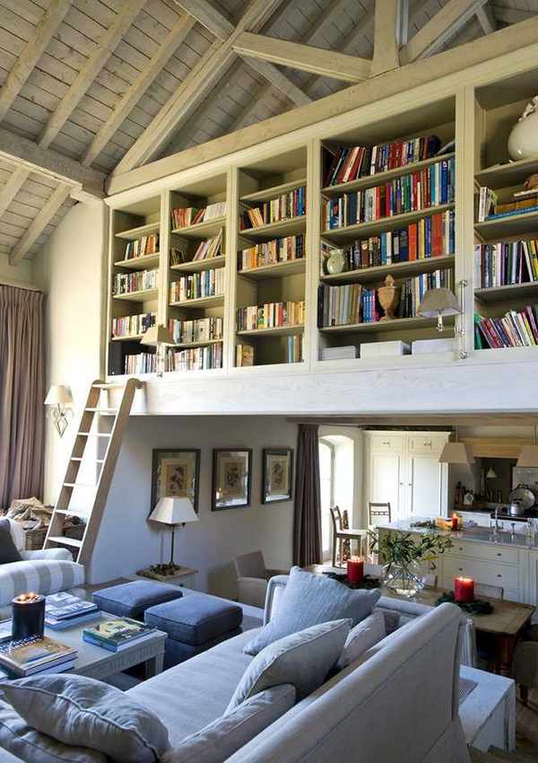 Open plan living room kitchen with home library shelving above