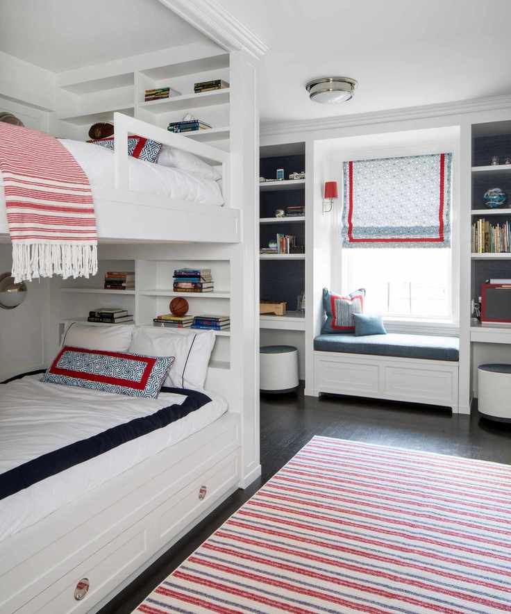 A kids' room featuring white bunk beds with colorful soft furnishings