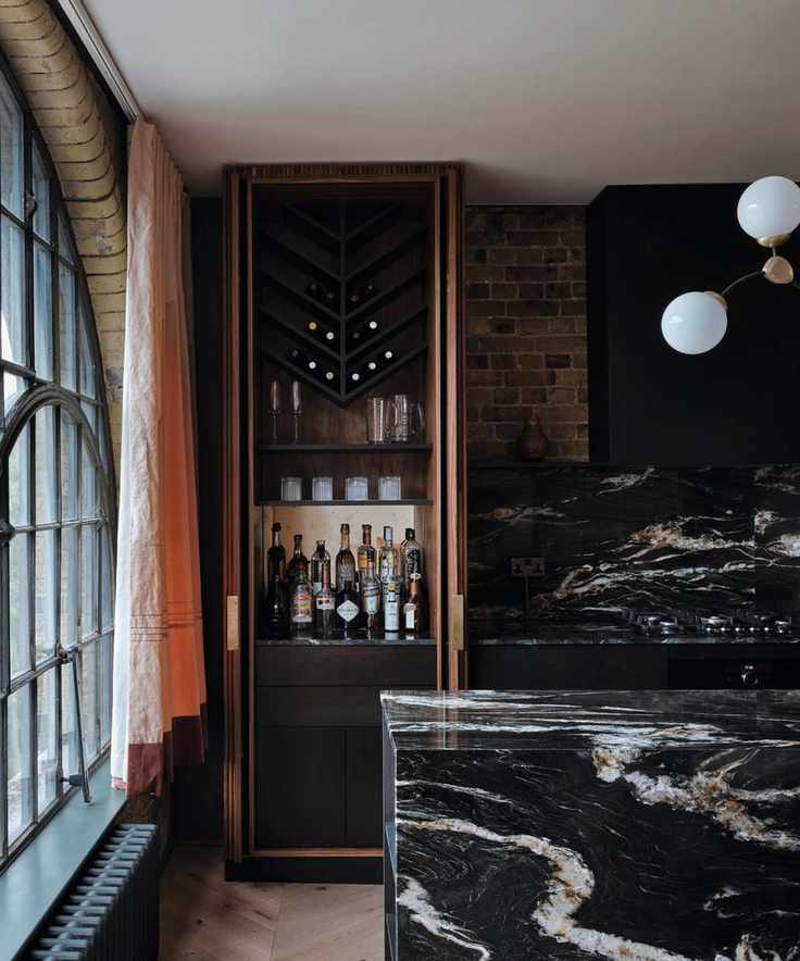 homebar in inbuilt cabinet with black marble kitchen