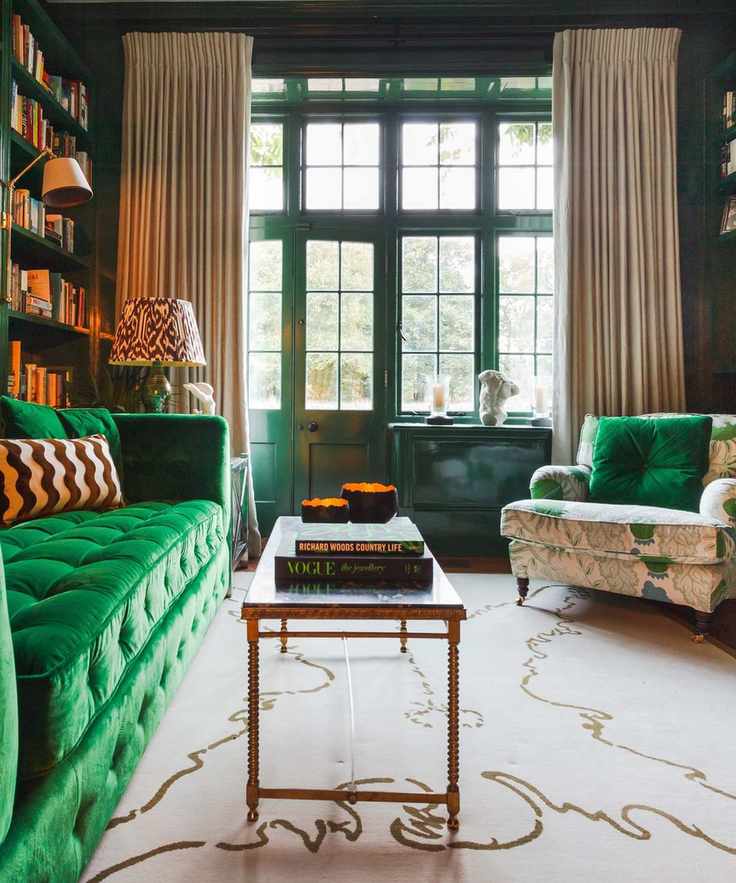 living room with green button back sofa and botanical armchair