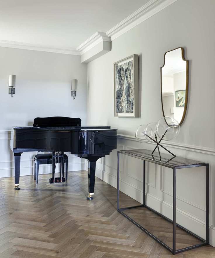 A modern hallway with gray walls and a black console table