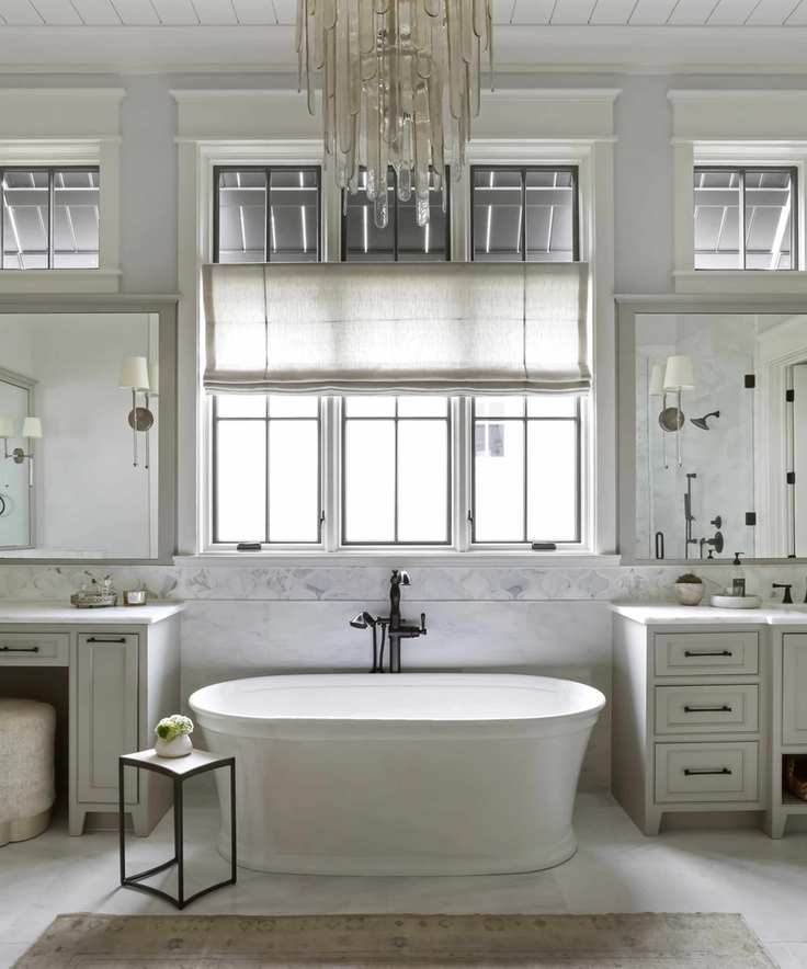 Elegant bathroom featuring a freestanding bath and chandelier