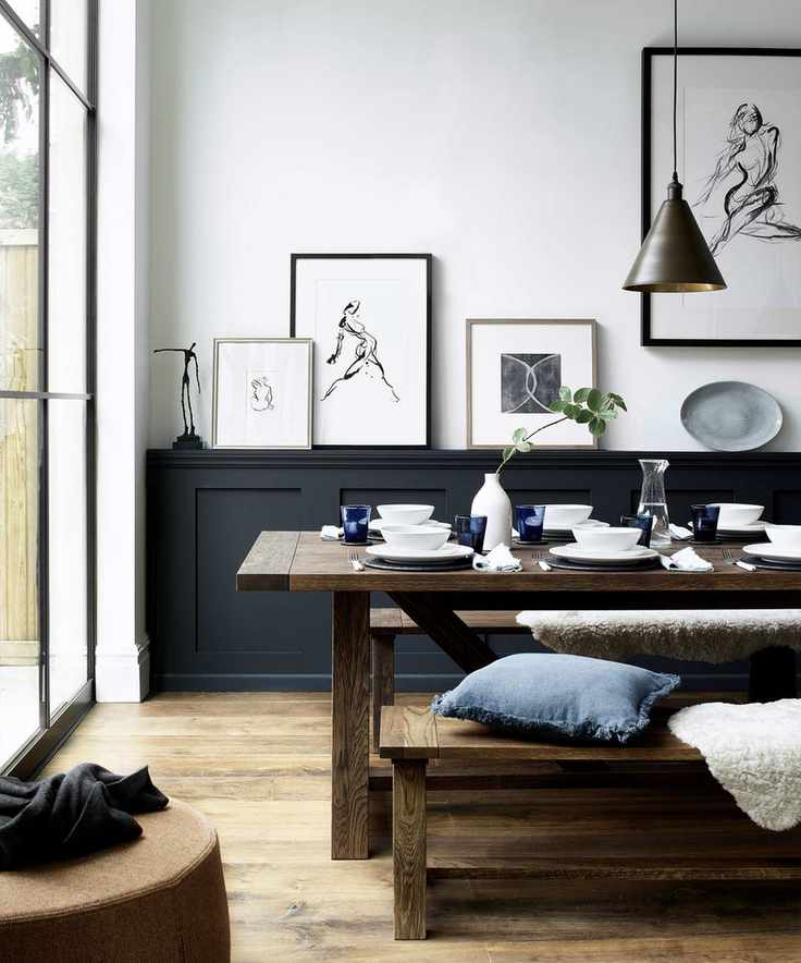 Dining room with black paneling and white walls