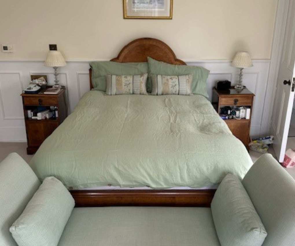 Piglet in Bed Sage Green Bedding Bundle on a bed against a cream wall.