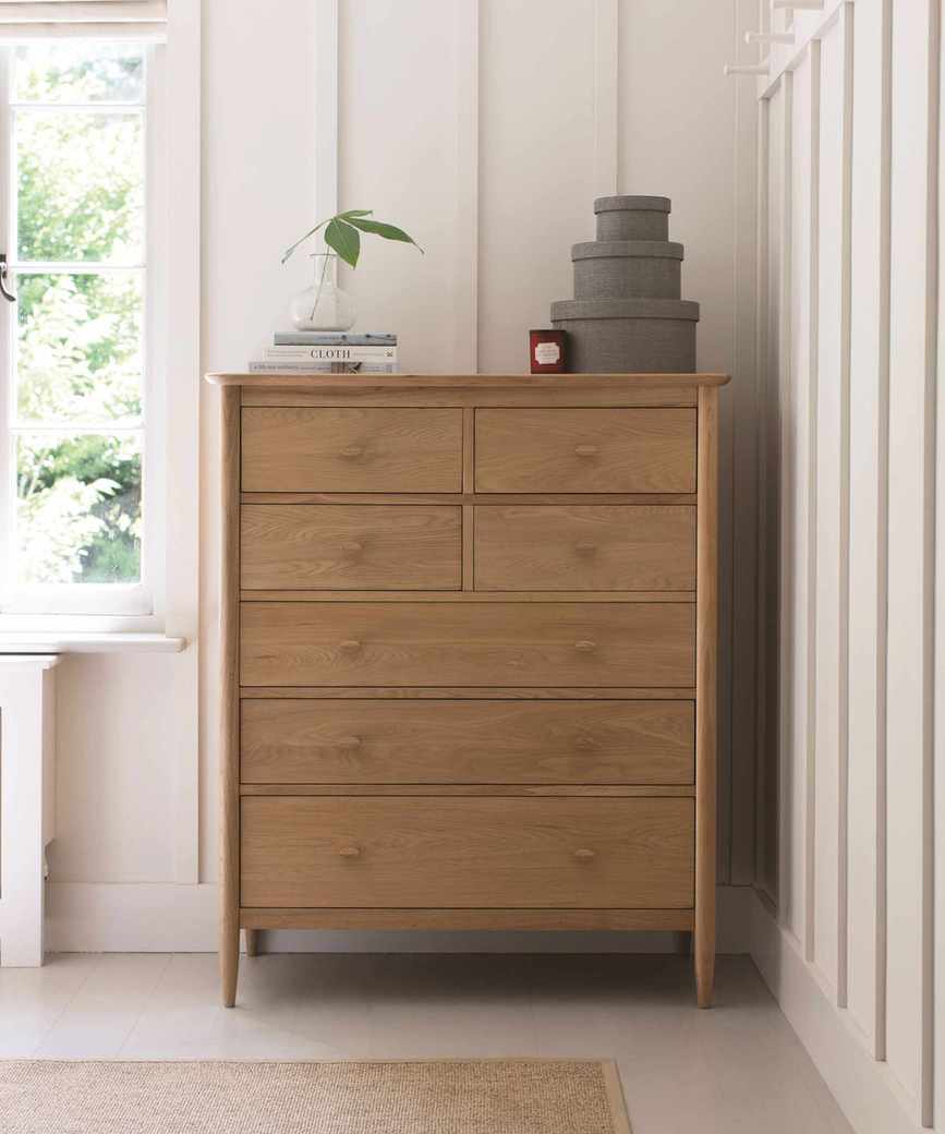 Stylish bedroom featuring a tall wooden chest for storage
