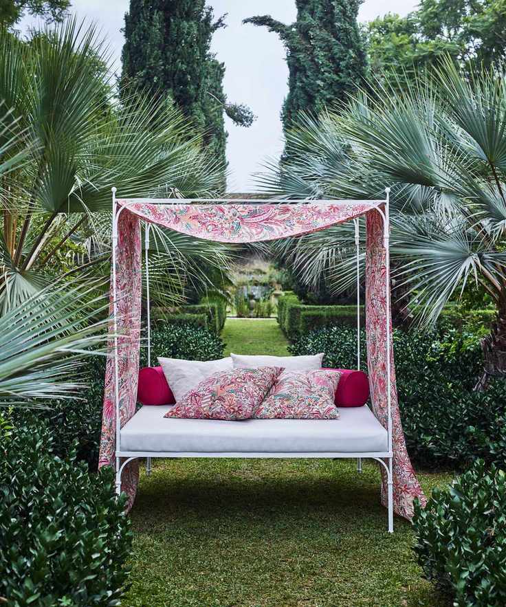 Outdoor daybed with colorful fabric in a garden